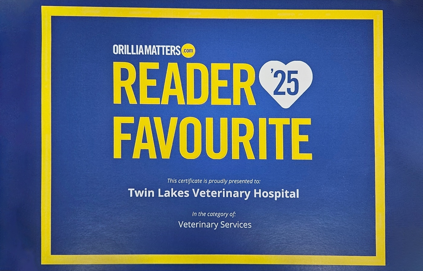 A blue and yellow certificate reading "OrilliaMatters.com Reader Favourite '25," awarded to Twin Lakes Veterinary Hospital for Veterinary Services.